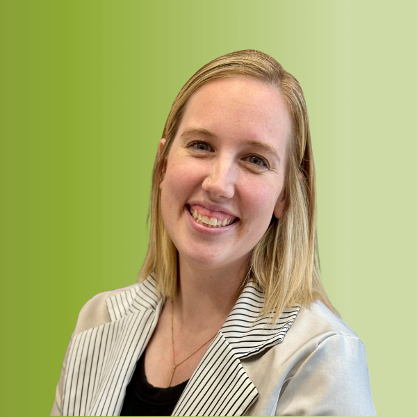 Person wearing a light-colored blazer with black stripes over a black top, against a green gradient background.