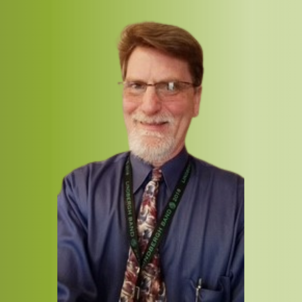 Person wearing a dark blue dress shirt with a patterned tie and a lanyard, against a green gradient background.