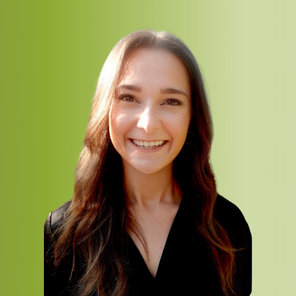 Person wearing a black top with long wavy hair, against a green gradient background.