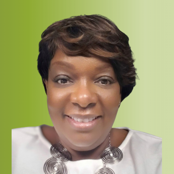 Person wearing a white top with a large circular silver necklace, against a green gradient background.