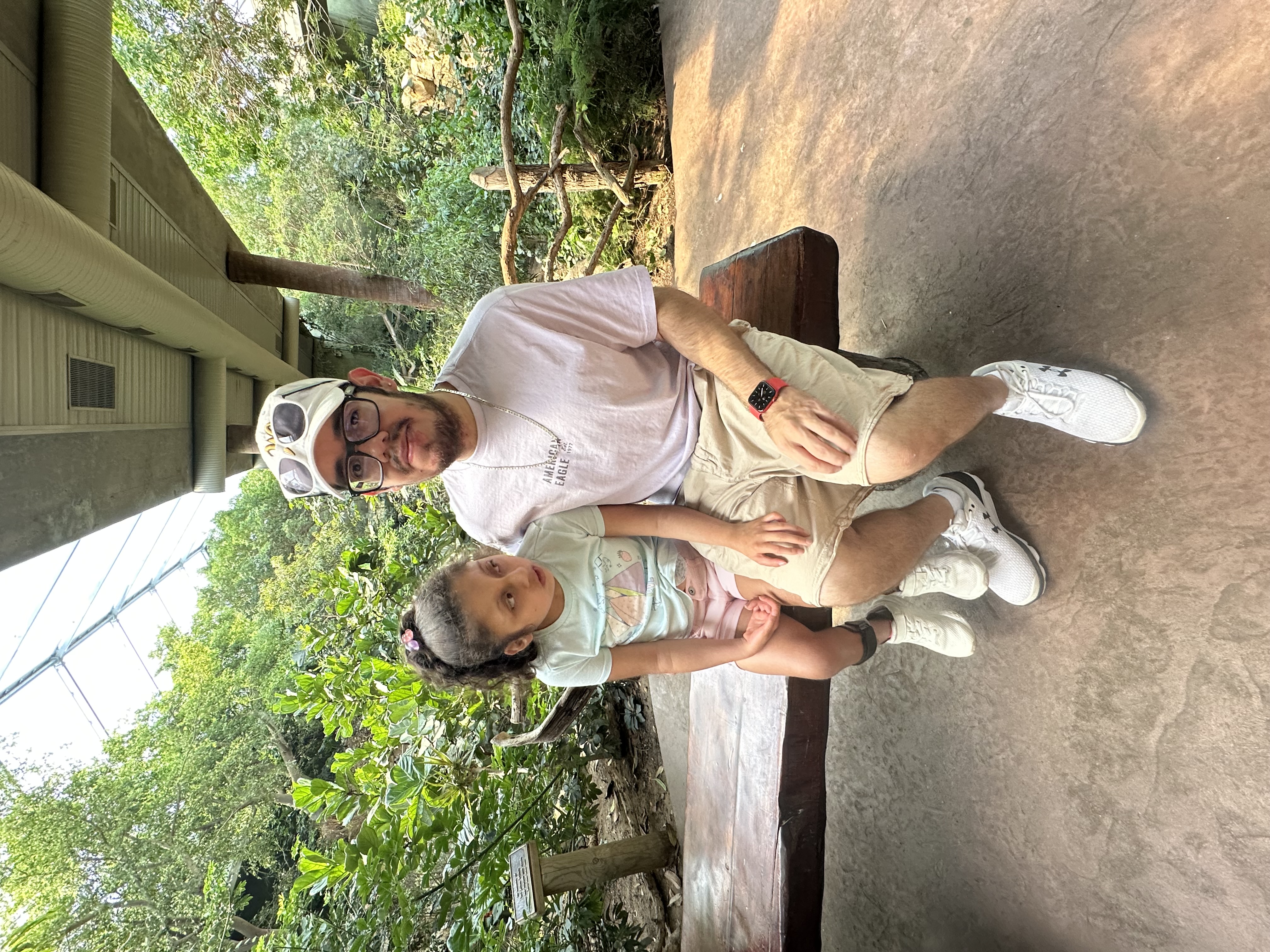 Missael and his daughter, Irasema, on a bench outside