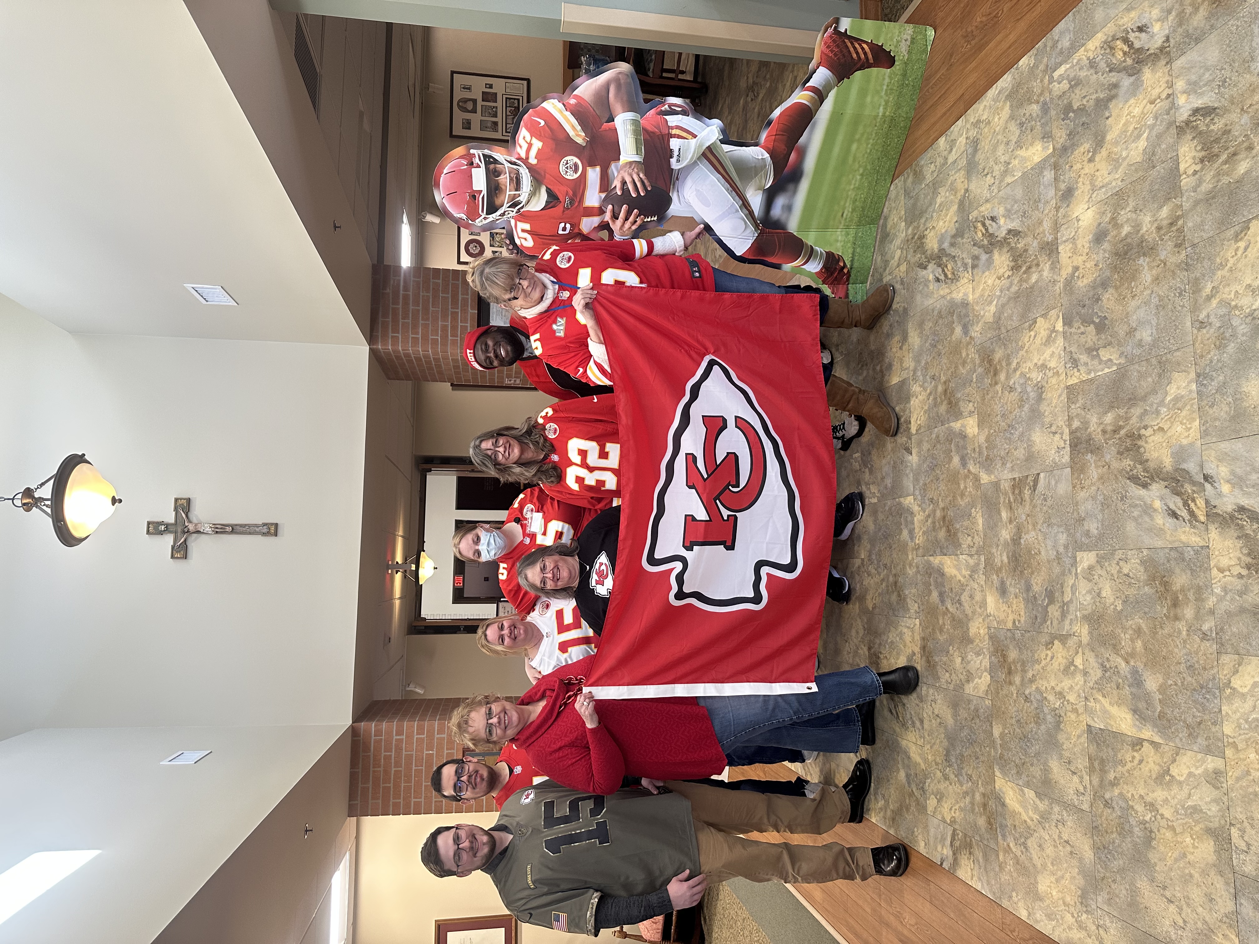 Missael with his coworkers in Kansas City Chiefs apparel